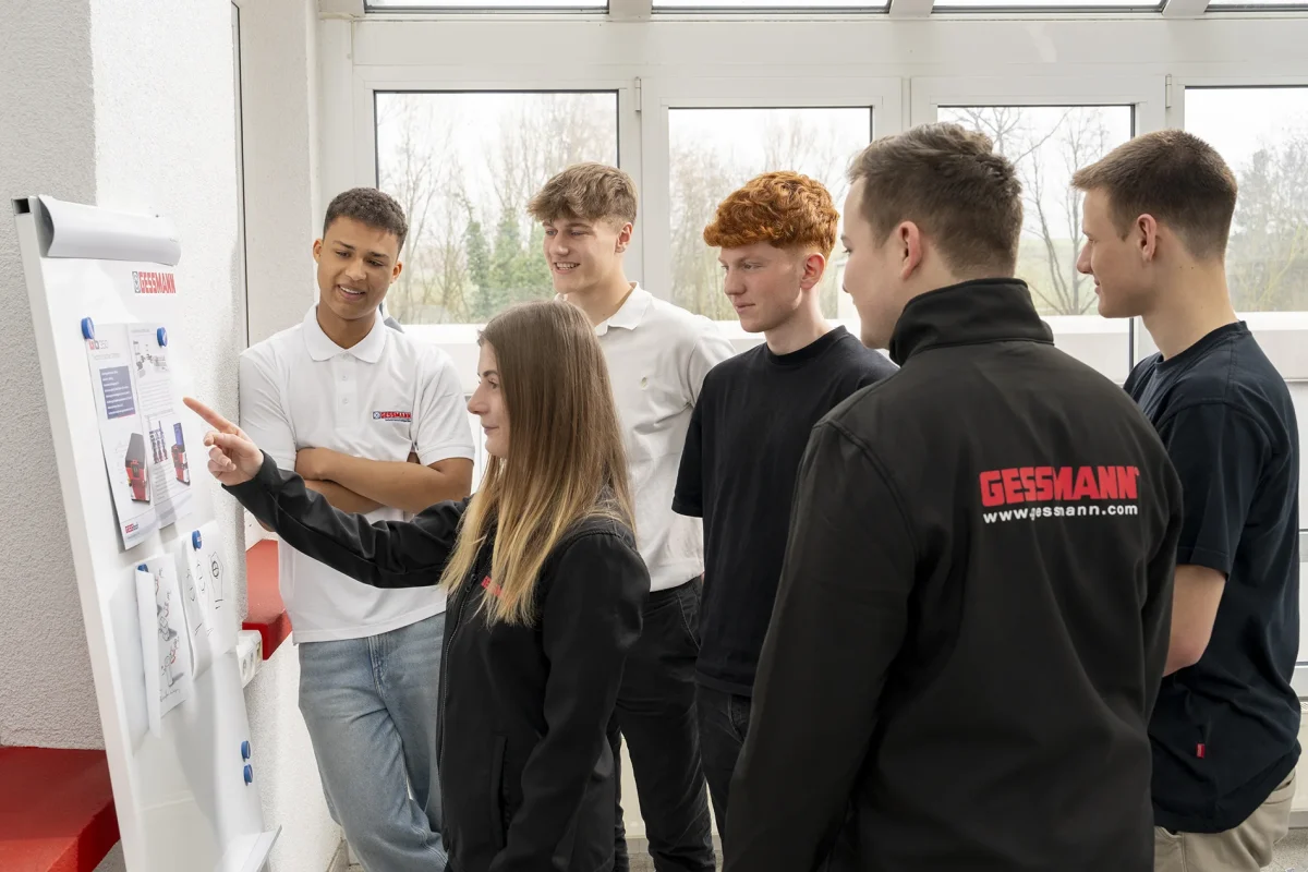 Apprentices discuss things at the whiteboard